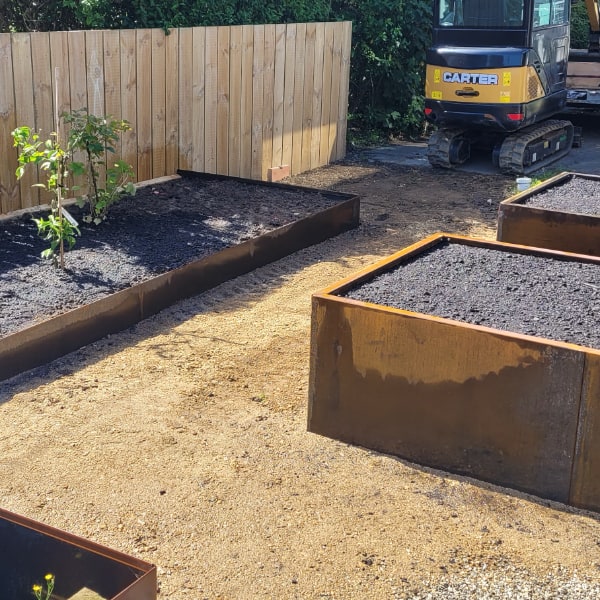 Corten steel fabricated planter boxes and garden edging