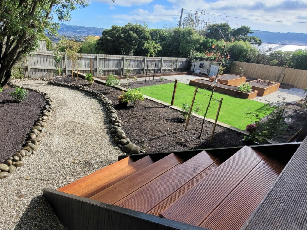 Backyard re-imagined with new paths, garden beds and plantings
